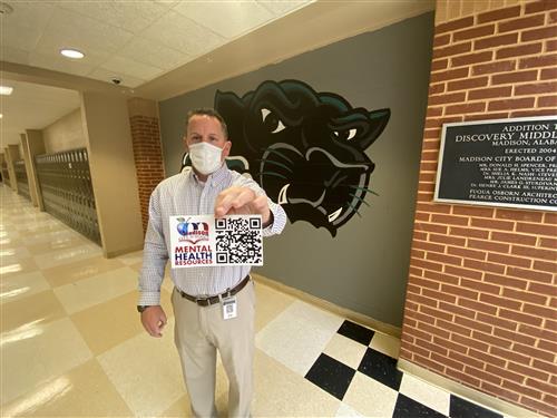 Discovery Middle Principal Jamie Hill holding placard